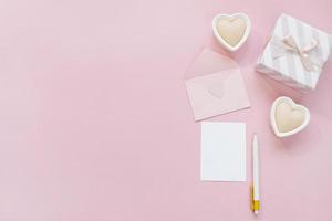 feliz dia dos namorados composição. maquete de cartão em branco, caixas de presente, corações, confetes em fundo rosa foto