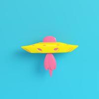 ufo amarelo ou nave alienígena em fundo azul brilhante em tons pastel foto