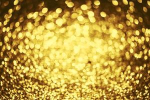 textura de iluminação de bokeh de brilho dourado turva fundo abstrato para aniversário, aniversário, casamento, véspera de ano novo ou natal foto