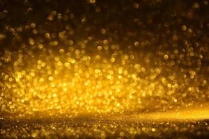 textura de iluminação de bokeh de brilho dourado turva fundo abstrato para aniversário, aniversário, casamento, véspera de ano novo ou natal foto