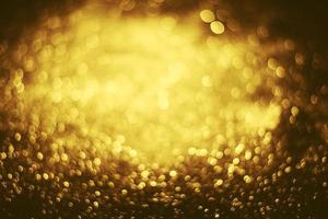 textura de iluminação de bokeh de brilho dourado turva fundo abstrato para aniversário, aniversário, casamento, véspera de ano novo ou natal foto