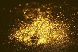 textura de iluminação de bokeh de brilho dourado turva fundo abstrato para aniversário, aniversário, casamento, véspera de ano novo ou natal foto