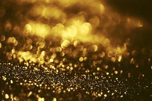 textura de iluminação de bokeh de brilho dourado turva fundo abstrato para aniversário, aniversário, casamento, véspera de ano novo ou natal foto