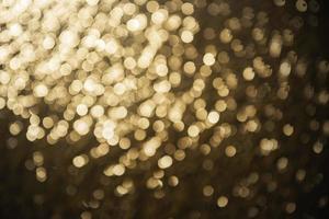 textura de iluminação de bokeh de brilho dourado turva fundo abstrato para aniversário, aniversário, casamento, véspera de ano novo ou natal foto