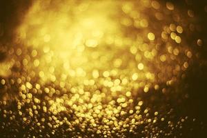 textura de iluminação de bokeh de brilho dourado turva fundo abstrato para aniversário, aniversário, casamento, véspera de ano novo ou natal foto