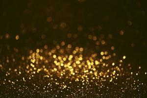 textura de iluminação de bokeh de brilho dourado turva fundo abstrato para aniversário, aniversário, casamento, véspera de ano novo ou natal foto