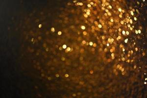 textura de iluminação de bokeh de brilho dourado turva fundo abstrato para aniversário, aniversário, casamento, véspera de ano novo ou natal foto