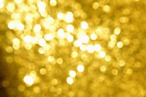 textura de iluminação de bokeh de brilho dourado turva fundo abstrato para aniversário, aniversário, casamento, véspera de ano novo ou natal foto