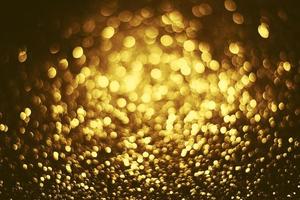 textura de iluminação de bokeh de brilho dourado turva fundo abstrato para aniversário, aniversário, casamento, véspera de ano novo ou natal foto