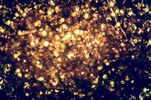 textura de iluminação de bokeh de brilho dourado turva fundo abstrato para aniversário, aniversário, casamento, véspera de ano novo ou natal foto