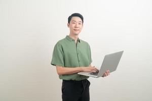 jovem asiático usando laptop disponível foto