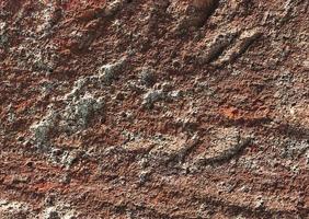 superfície de parede de rocha marrom vermelho escuro, textura de fundo abstrato. foto