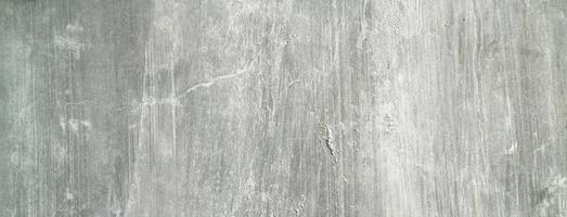 velho muro de concreto sujo como pano de fundo. gesso de cimento cinza. textura de parede para plano de fundo. escova arranhões na parede foto