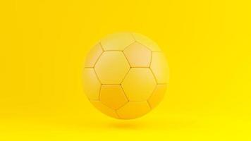 bola de futebol amarela sobre fundo amarelo. foto