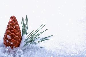 cartão de Natal. galho de pinheiro e brinquedos em um fundo de neve branca. foto