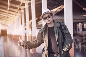 homem de viagem está esperando trem na estação de trem, chiangmai tailândia, 23 de maio de 2019 foto