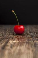 cerejas maduras vermelhas em uma mesa de madeira foto