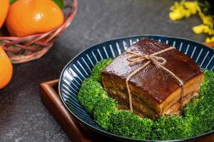 dong po rou dongpo carne de porco em um belo prato com vegetais de brócolis verde, comida tradicional festiva para refeição de cozinha de ano novo chinês, close-up. foto