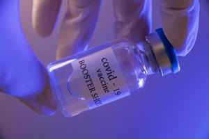 frasco de vacina de reforço covid-19. conceito de medicina e saúde foto