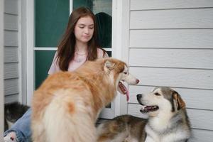 jovem em roupas casuais, abraçando o golden retriever enquanto está sentado no chão foto