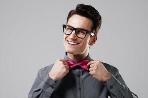 homem sorridente com gravata borboleta rosa foto