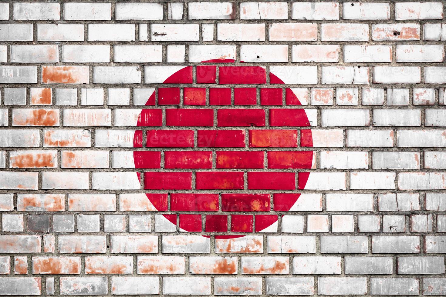 Nationalflagge Japans auf einem Grunge-Backstein-Hintergrund. foto