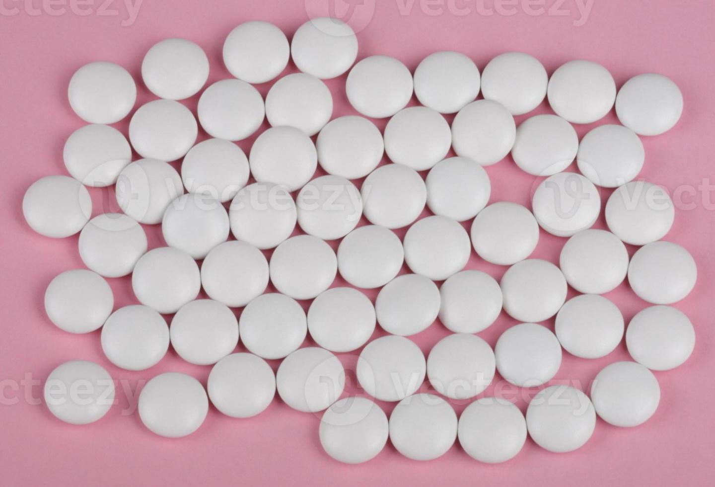 weiße Pille auf rosa Hintergrund foto