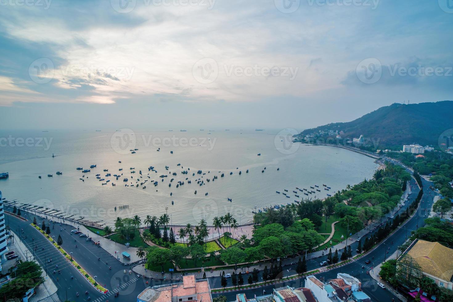 Luftaufnahme der Stadt Vung Tau mit wunderschönem Sonnenuntergang und so vielen Booten. Panoramablick auf die Küste von Vung Tau von oben, mit Wellen, Küste, Straßen, Kokospalmen und dem Berg Tao Phung in Vietnam. foto