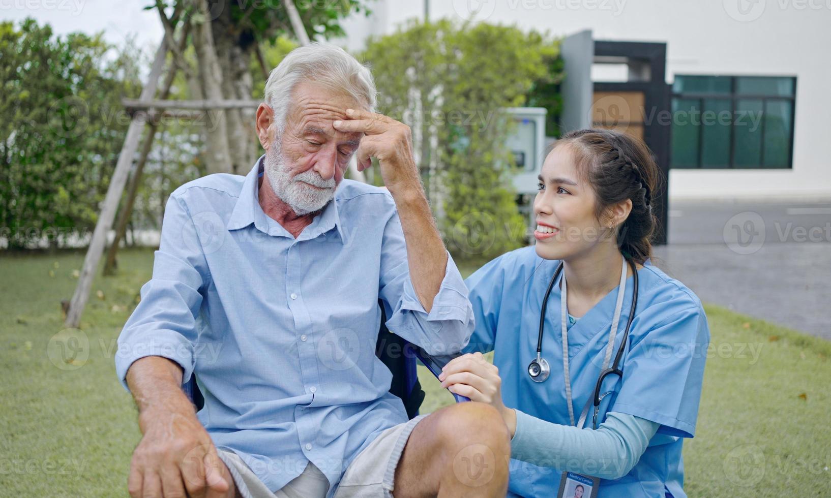 Depressiver männlicher Patient, der im Rollstuhl weint. junge Pflegekraft, die ihn tröstet. unglücklicher älterer mann mit geriatrischer oder depressionskrankheit. Therapeut, der sich umsorgt, Unterstützung und Empathie gibt. foto