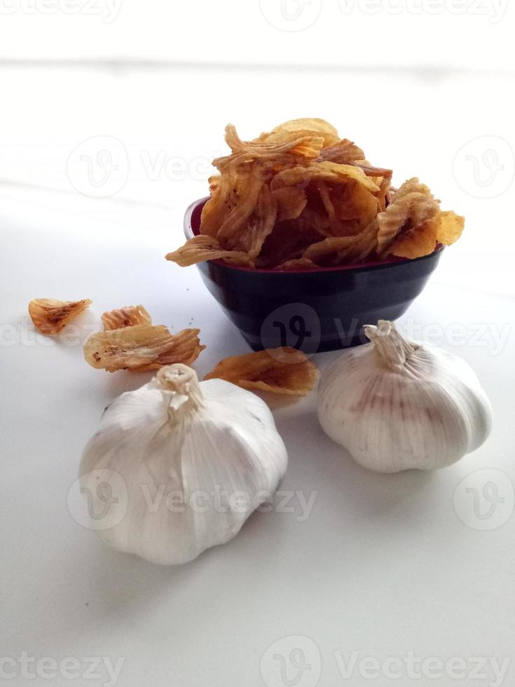 Bananenchips mit Knoblauch in weißem Hintergrund foto