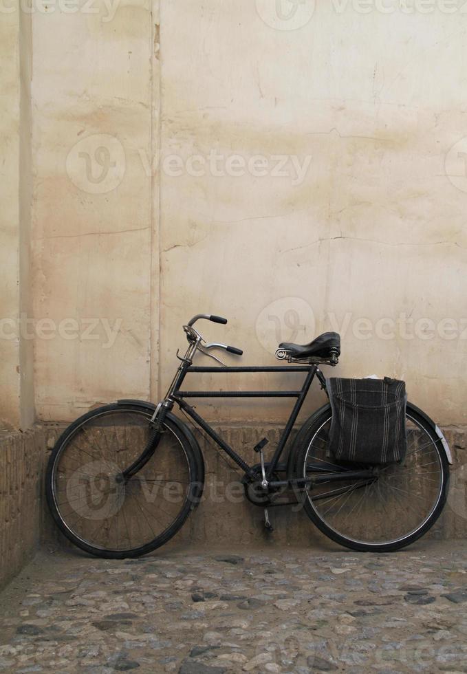 Vintage Fahrrad an eine Wand gelehnt foto