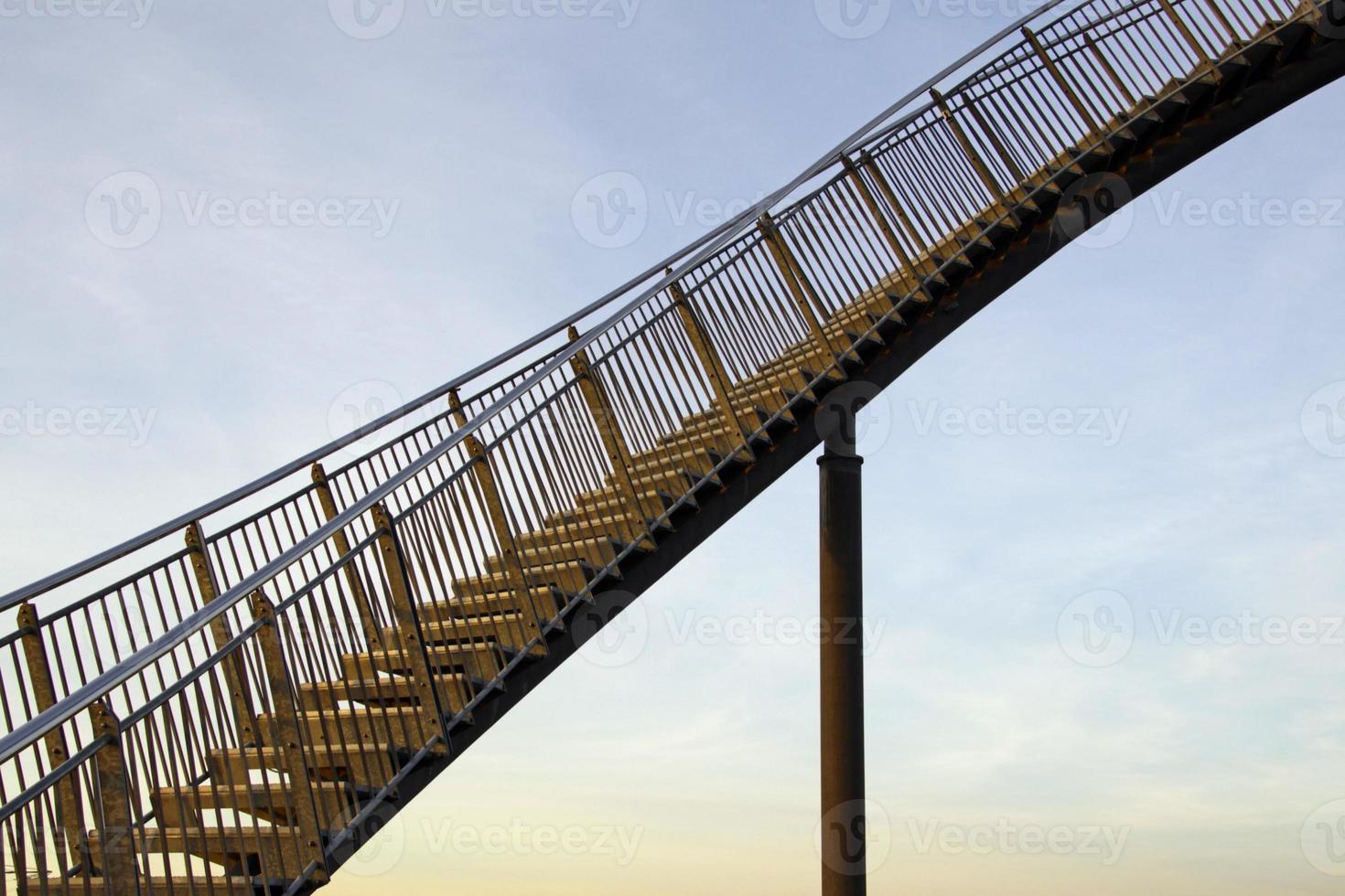 Karrierestufen - eine steile Treppe nach oben vor dem Nachmittagshimmel foto