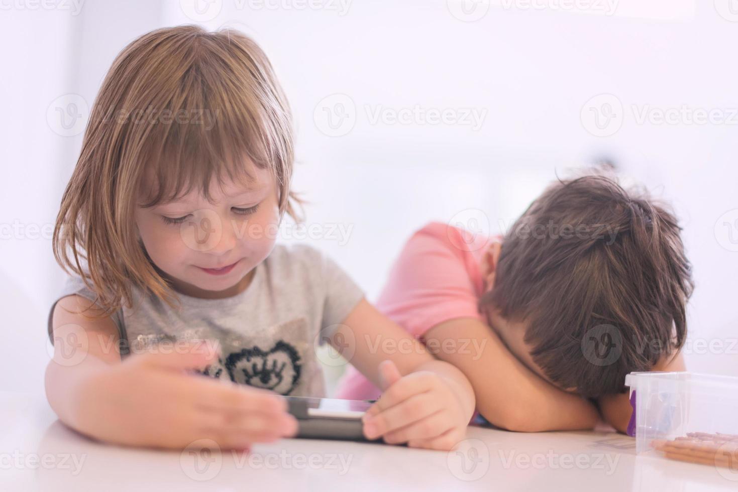 süßer kleiner bruder und schwester, die sich zu hause amüsieren foto