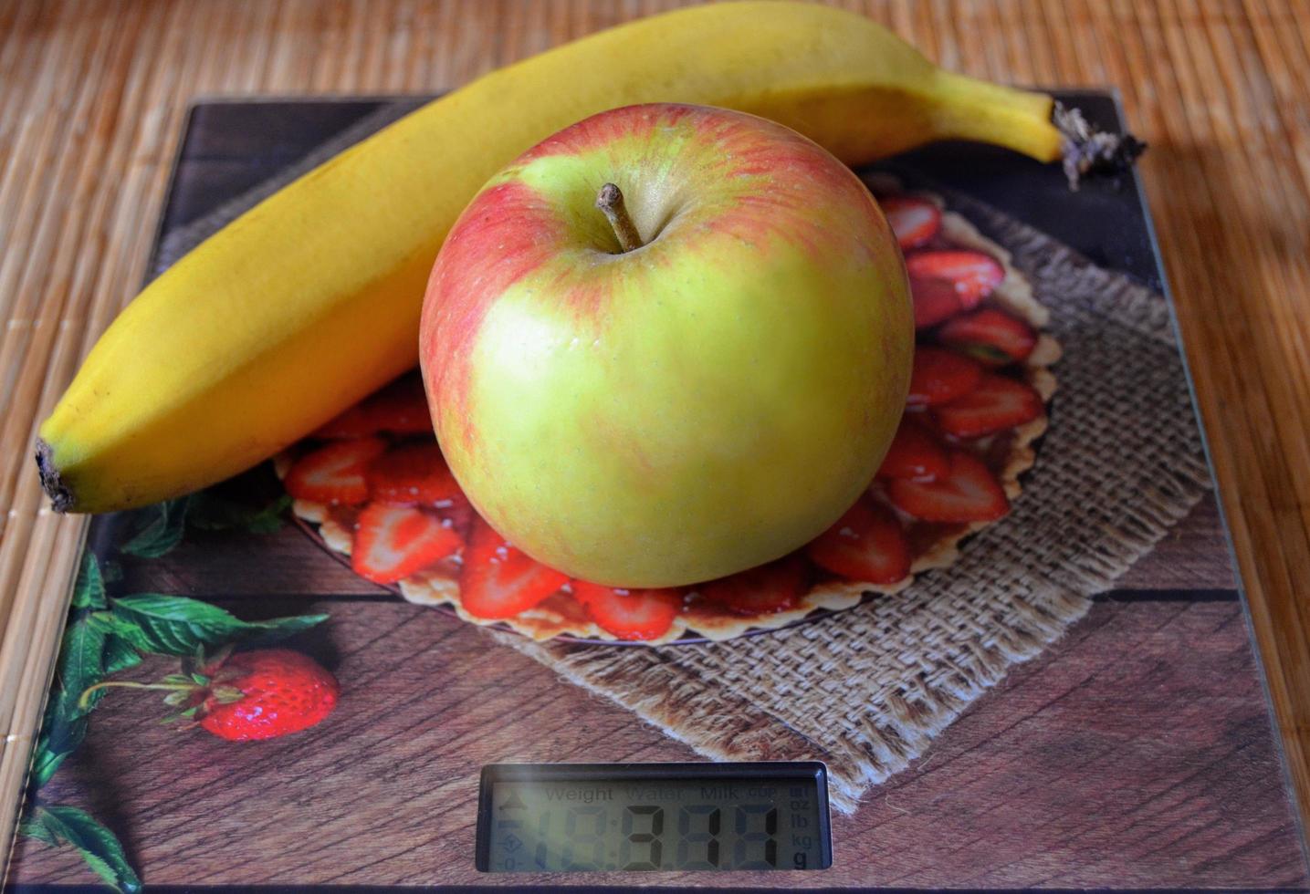 Apfel und Banane auf der Waage. Thema Kochen zu Hause, gesunde Ernährung, Ernährung. foto