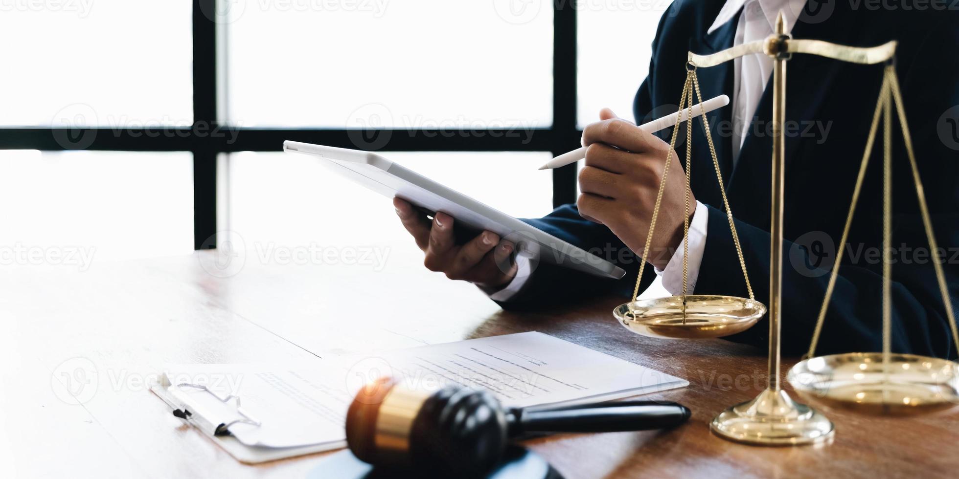 rechts- und rechtsdienstleistungskonzept, gute servicezusammenarbeit, anwaltshände mit tablet und arbeiten am holztischbüro. foto