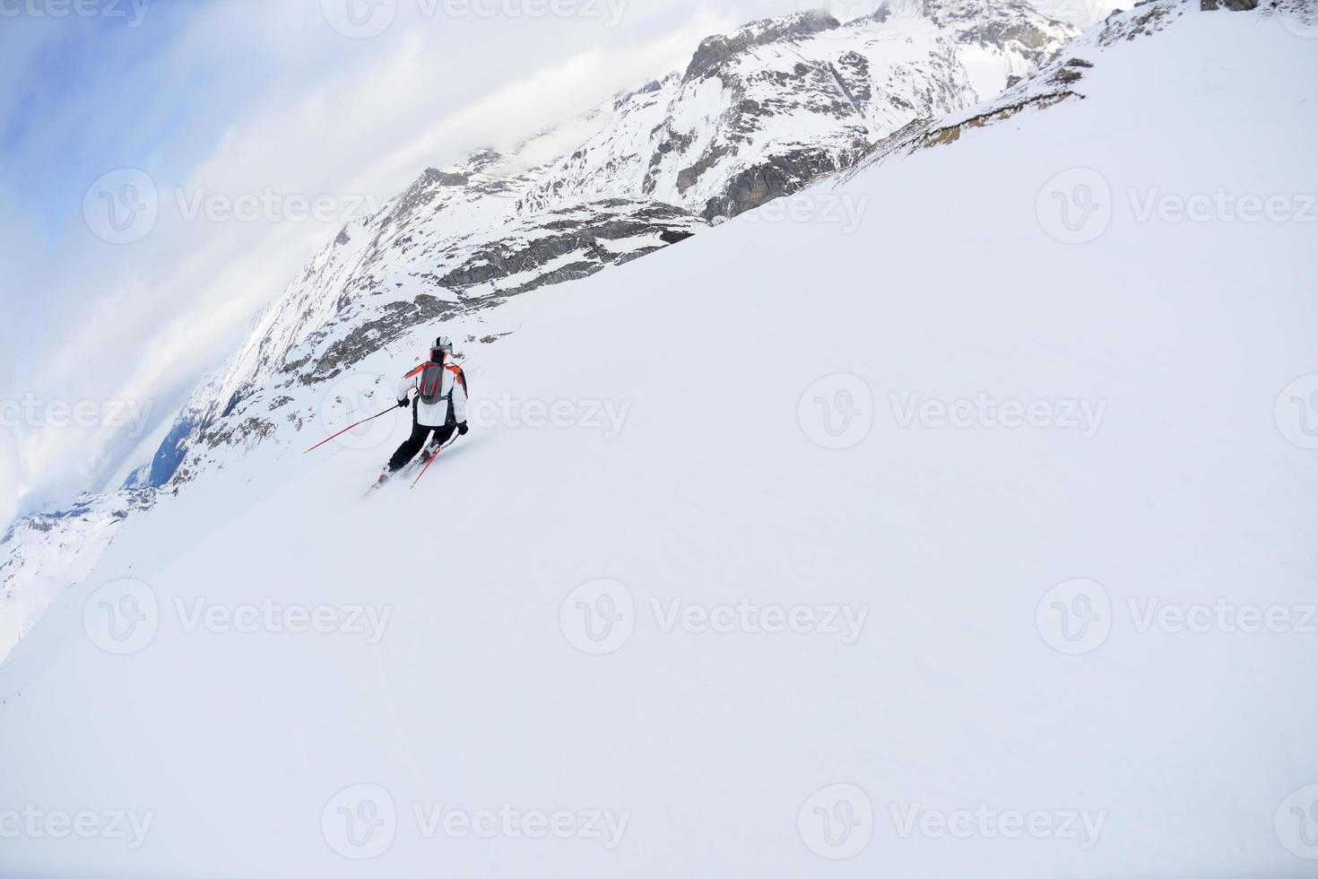 Skifahren auf Neuschnee in der Wintersaison am schönen sonnigen Tag foto