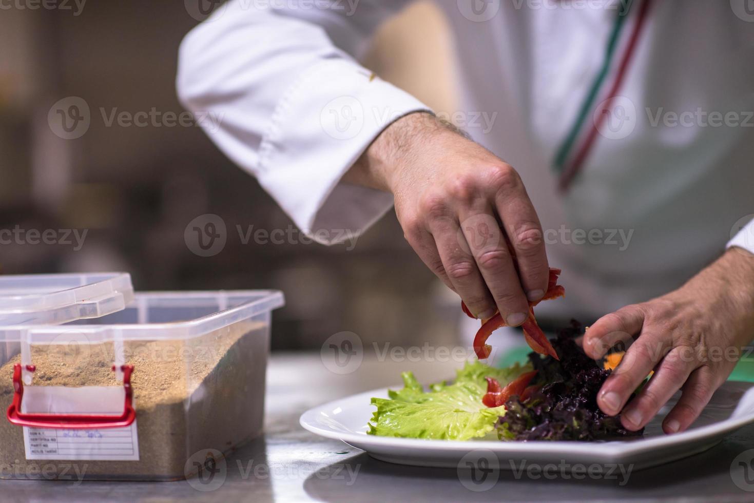 Koch serviert Gemüsesalat foto