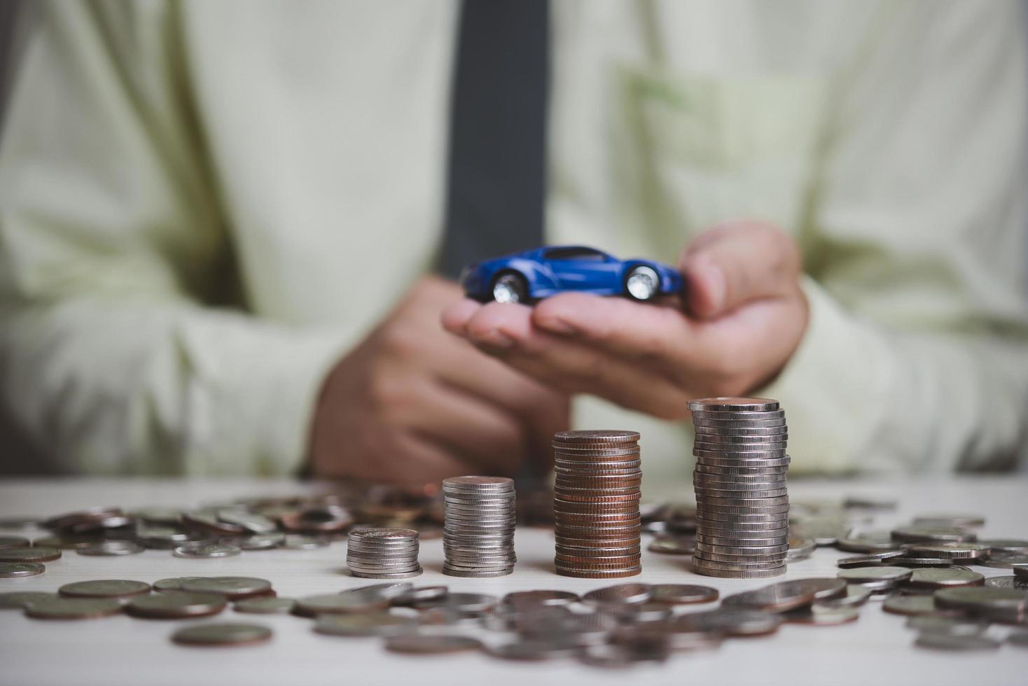 plan finanziert investitionen und einsparungen autos. geldmünze und auto auf dem tisch geschäftsbuchhaltung sowie steuer- und versicherungskonzept. foto