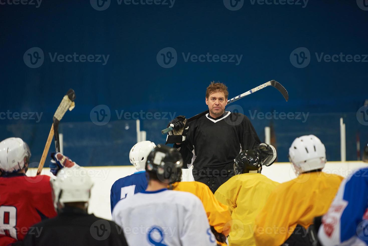 Mannschaftsbesprechung der Eishockeyspieler mit Trainer foto