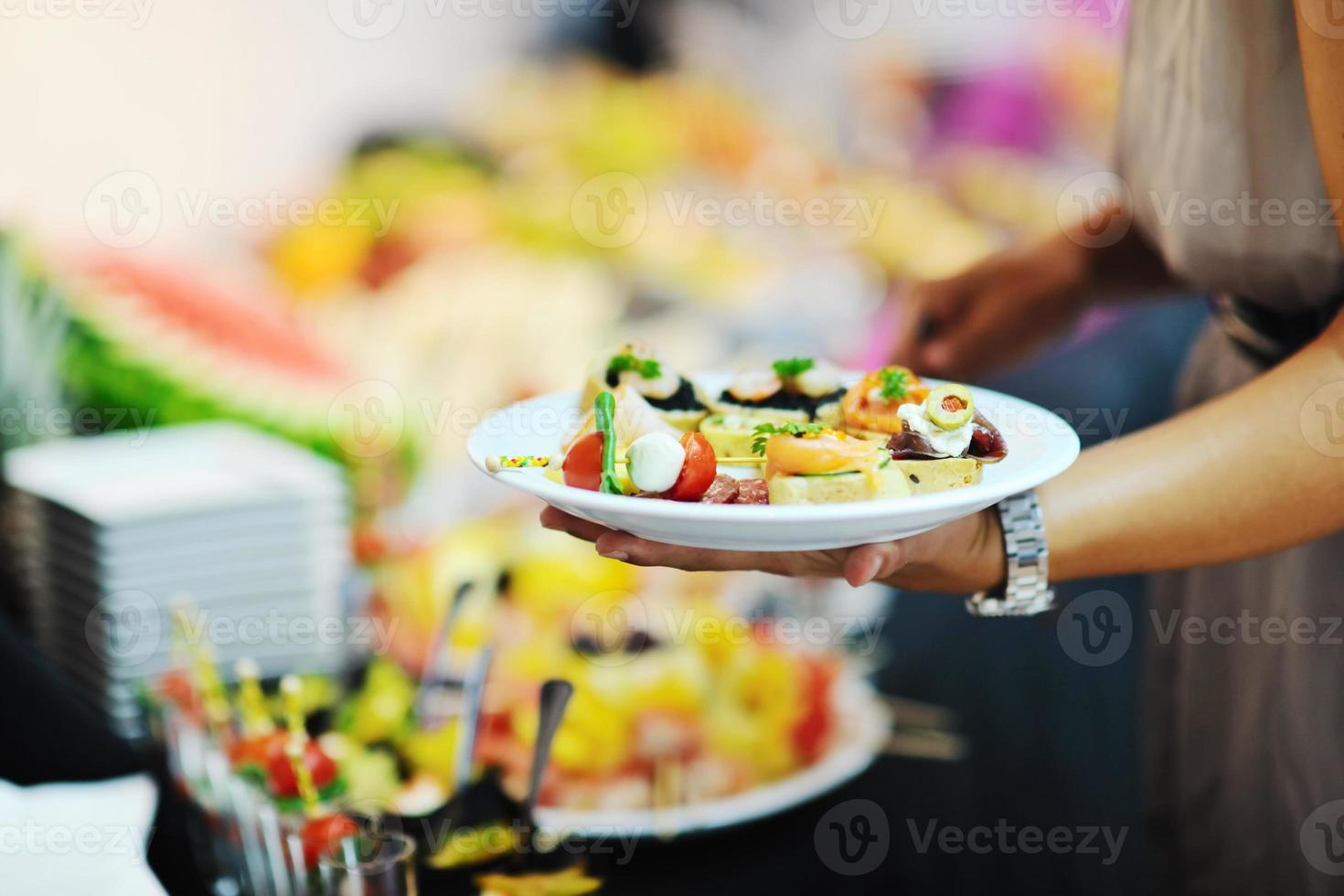 Womanl wählt leckeres Essen am Buffet im Hotel foto