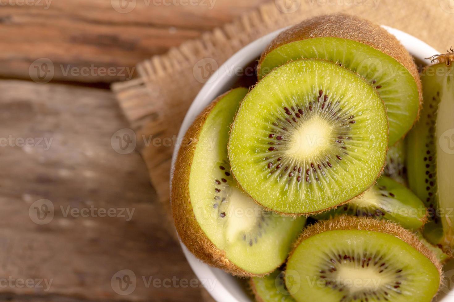 Kiwi-Scheiben in einer weißen Schüssel hautnah foto