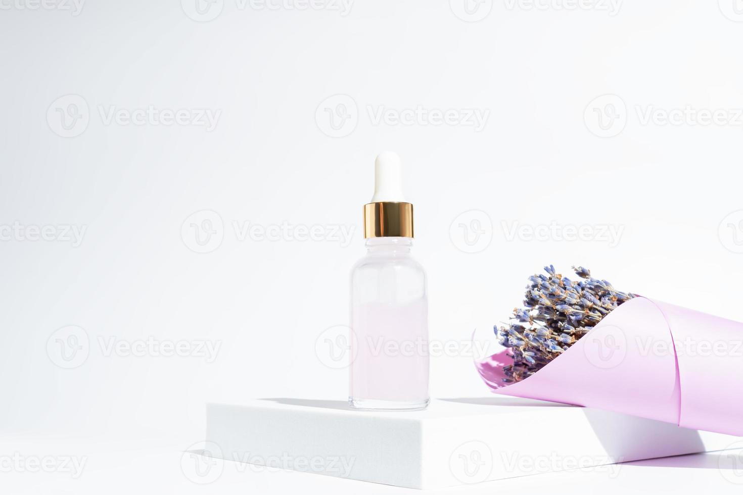 Lavendel-Schönheits-Gesichtsöl oder -Serum mit Lavendel-Extrakt auf weißem Hintergrund mit Haufen trockener Lavendelblüten. umweltfreundliche Naturkosmetik. Kopieren Sie Platz für Ihr Design foto