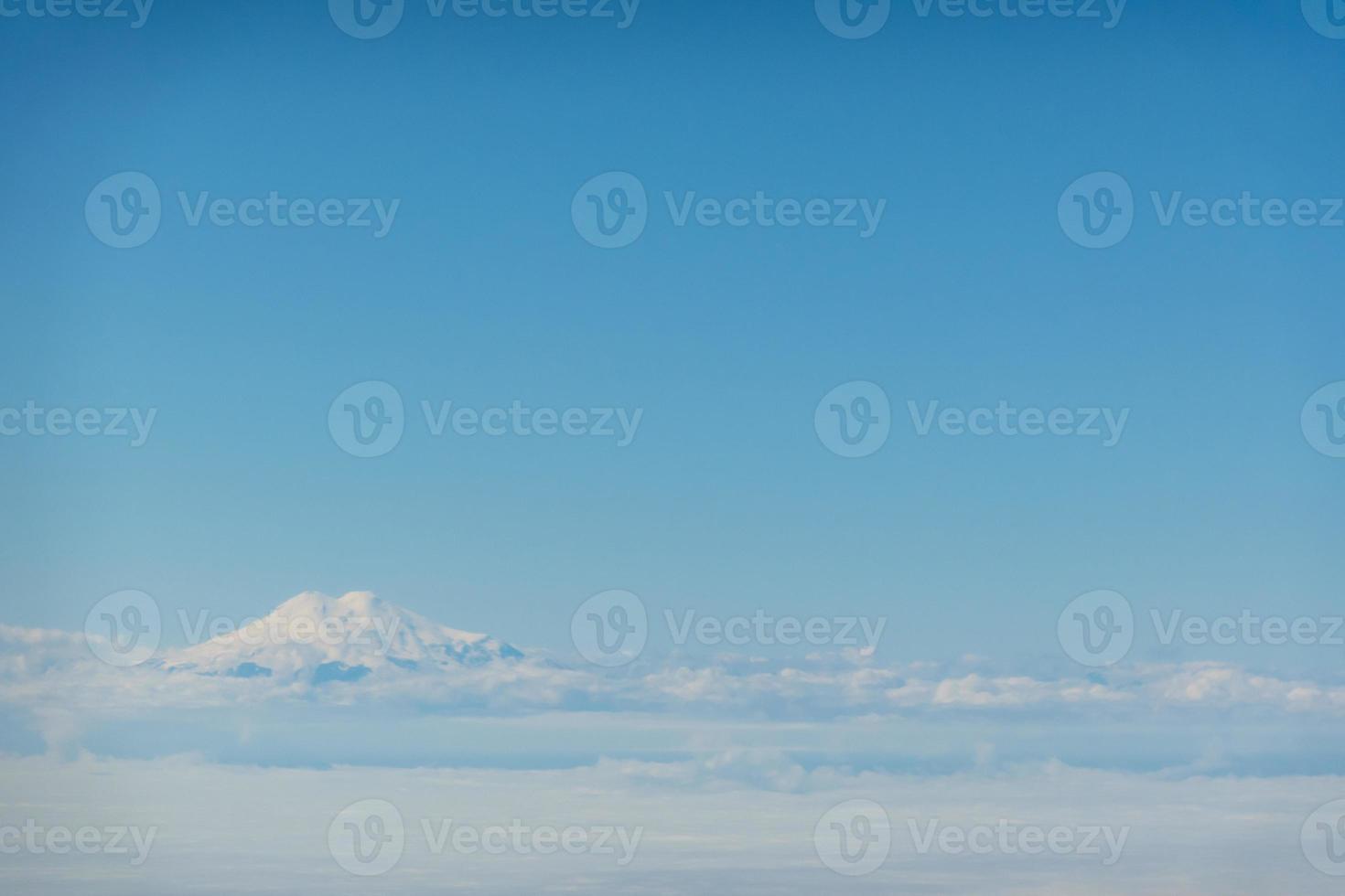 Luftaufnahme über Elbrus, Karatschai-Tscherkessien. Elbrus scheint durch die Wolken foto