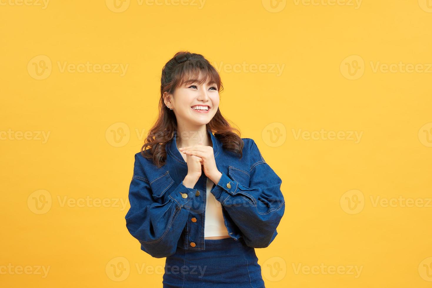 Nahaufnahmefoto einer aufgeregten, fröhlichen, fröhlichen, positiven, optimistischen jungen Dame, die Händchen hält und Sie isoliert auf gelbem Hintergrund betrachtet foto