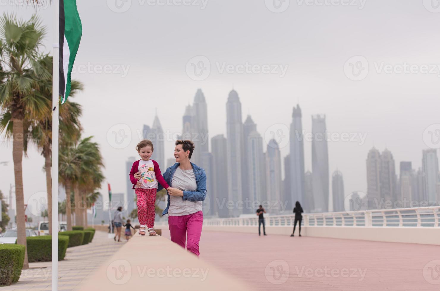 Mutter und süßes kleines Mädchen auf der Promenade foto