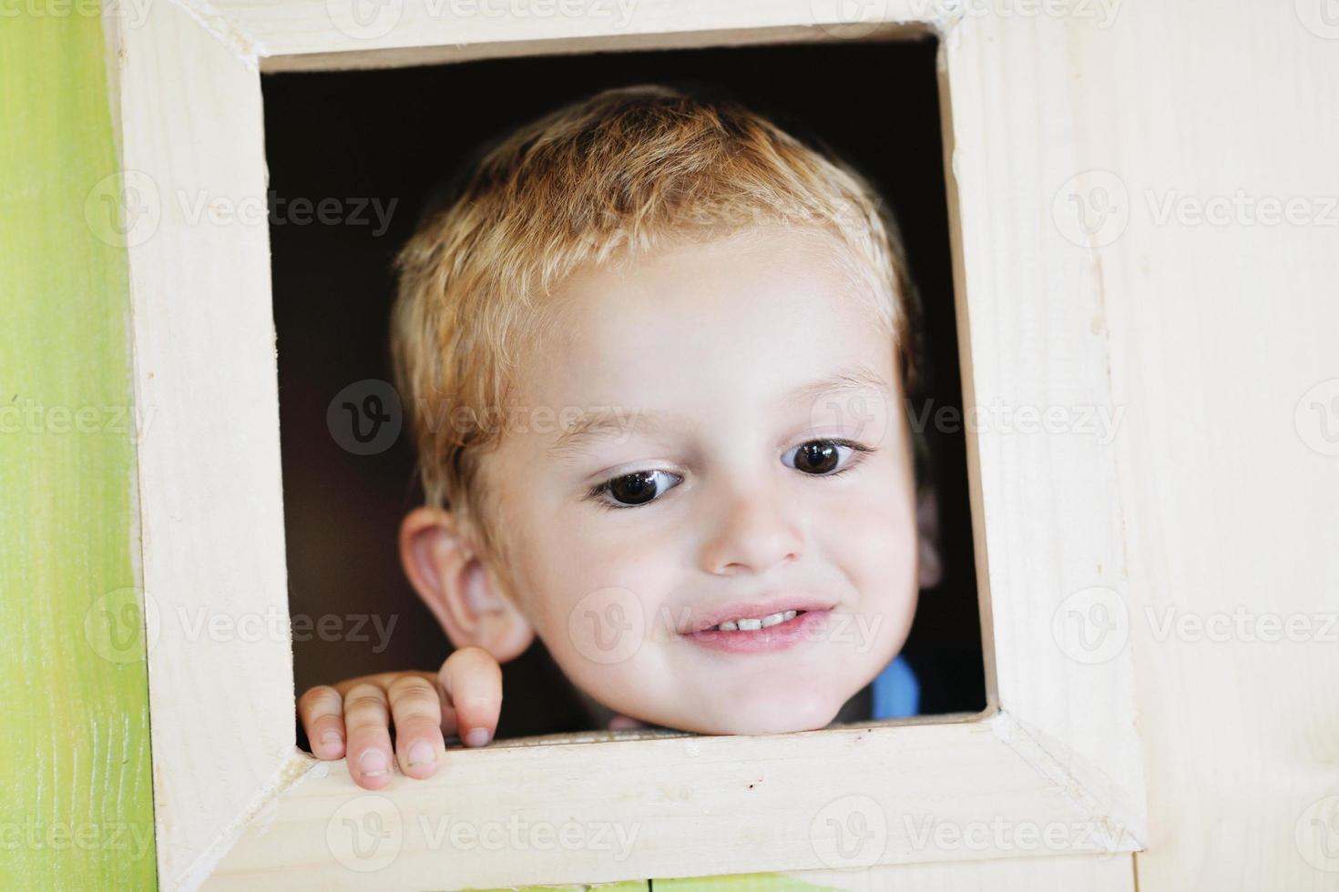 glückliches Kind in einem Fenster foto