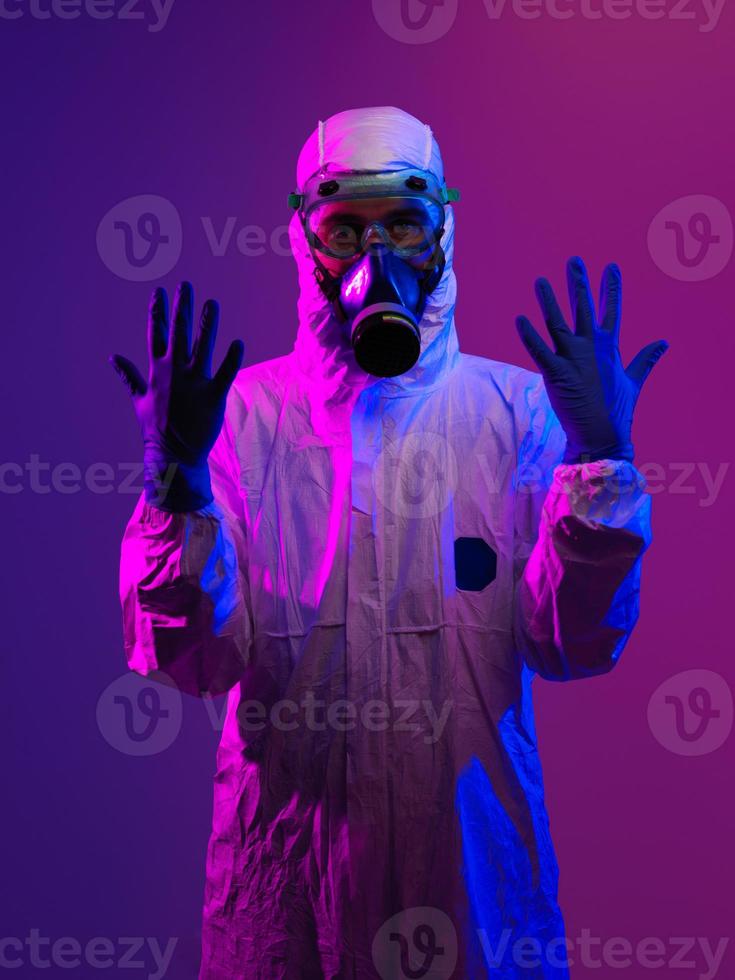 Arzt trägt biologischen Schutzanzug und Maske wegen Coronavirus foto