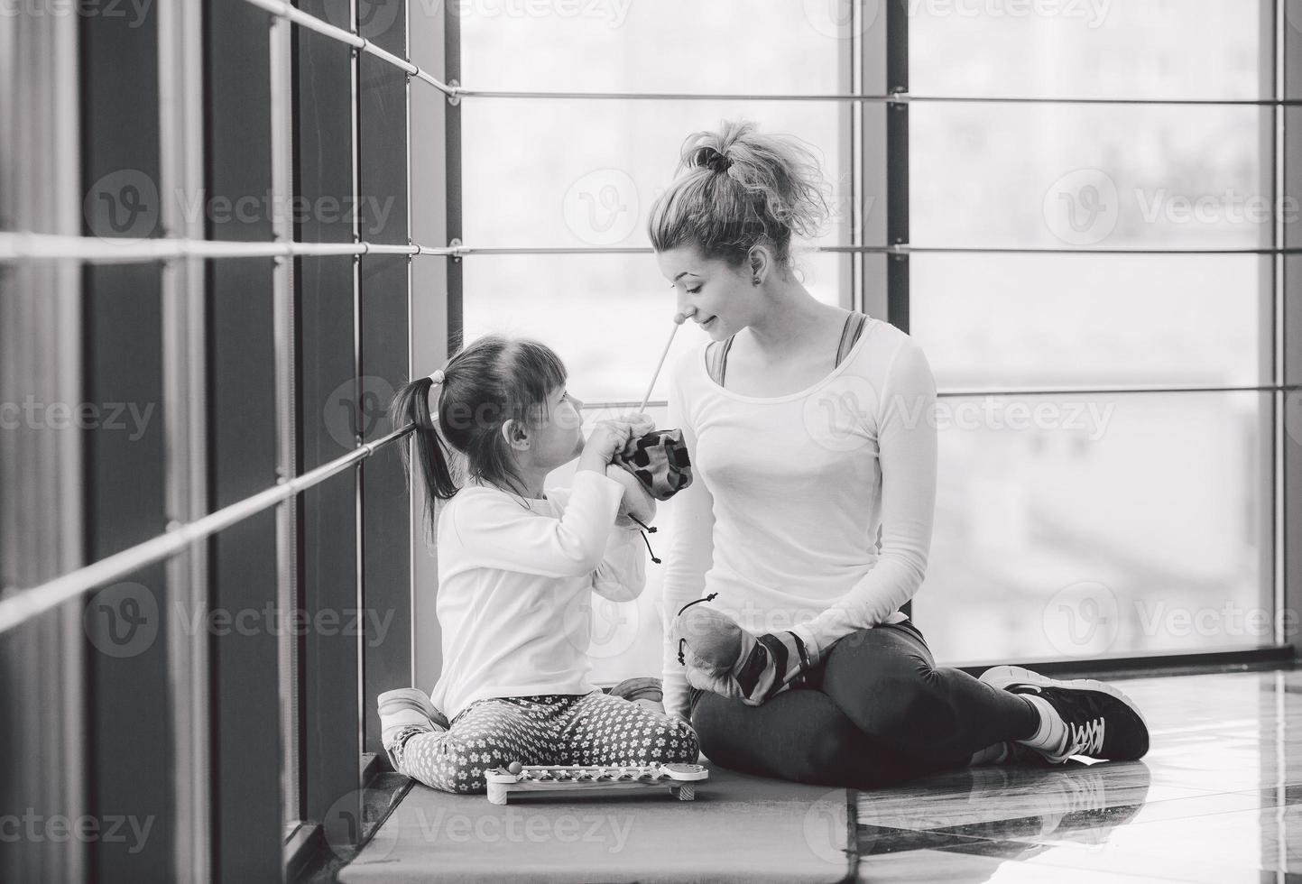 Mutter und Tochter spielen mit Spielzeug im Fitnessstudio foto