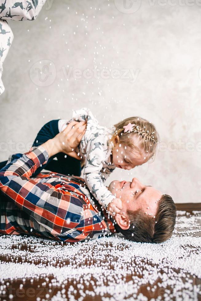 Papa spielt mit seiner Tochter auf dem Boden foto