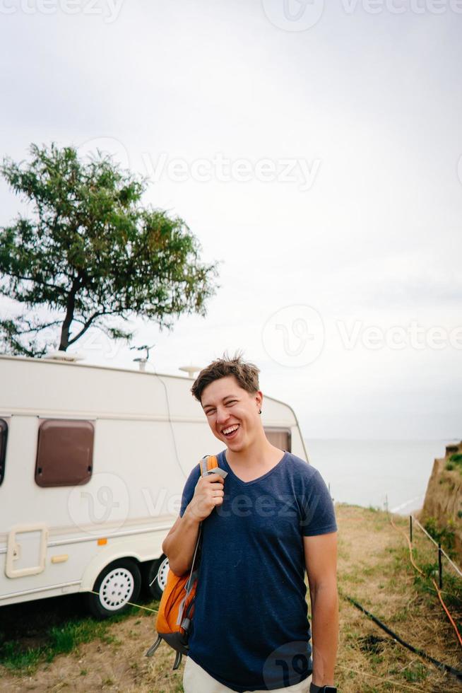 hübscher, junger Kerl, der an einer wilden Küste posiert foto